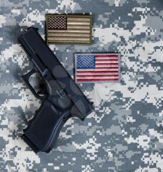 US flags and military pistol for Memorial, 4th of July and Veterans Day holiday 
