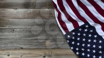 Large cloth American flag waving on vintage wooden planks