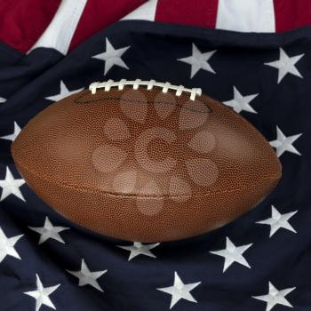 Leather football with American flag in background 