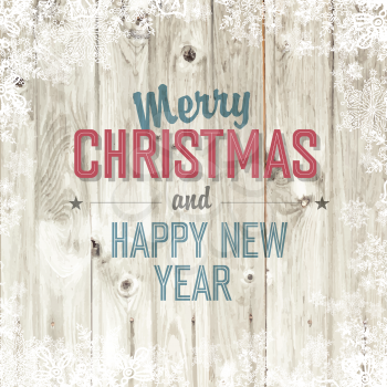 Merry Christmas greeting on blond wooden background