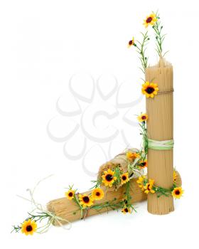 Uncooked Italian spaghetti decorated with yellow flowers isolated on white background
