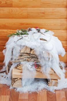 Stack of wood with Christmas decorations.