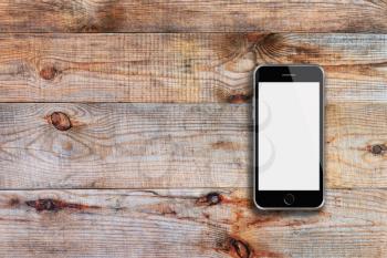 Mobile smart phone with white screen on wooden background. Highly detailed illustration.