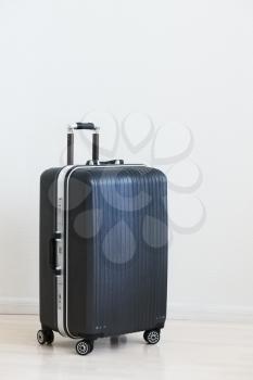 Large family polycarbonate luggage on white wooden background. 