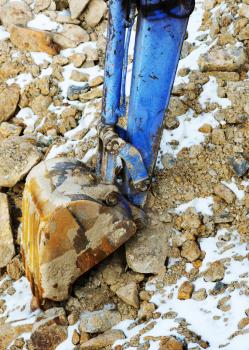 Small bulldozer excavator loader machine works outdoors at construction site.