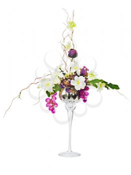  Floral arrangement from artificial flowers in glass goblet isolated on white background