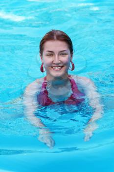 Young beautiful woman in swimming pool. Closeup
