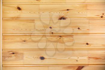 Light brown pine wood plank background. Closeup.