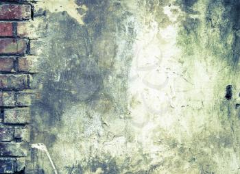 Grunge Background. The Old Brick Wall which has been Partially Covered with Concrete with Cracks and Dirt Spots.
