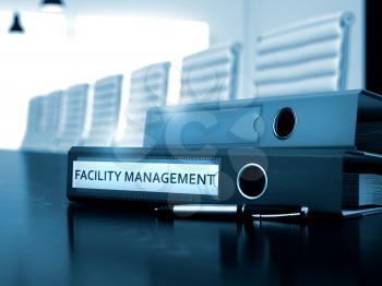 Facility Management - Office Binder on Wooden Working Desktop. Facility Management - Business Illustration. Facility Management - Business Concept on Blurred Background. Toned Image. 3D Render.