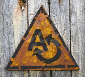 Royalty Free Photo of an A and Arrow on a Rusty Sign on a Weathered Wall