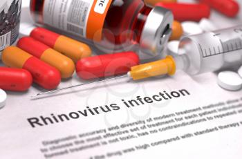 Rhinovirus Infection - Printed Diagnosis with Red Pills, Injections and Syringe. Medical Concept with Selective Focus.