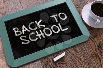 Back to School Handwritten by White Chalk on a Blackboard. Composition with Small Blue Chalkboard and Cup of Coffee. Top View.