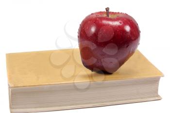 Royalty Free Photo of a Red Apple on a Book