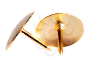 Two golden pin tacks isolated on a white background