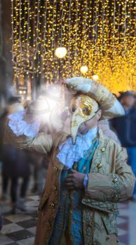Elaborate costumes at the Carnival  and light, Venice
