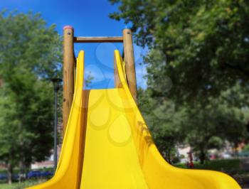 childrens slide in the park  with green trees