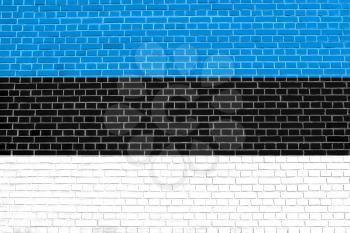 Flag of Estonia on brick wall texture background. Estonian national flag.