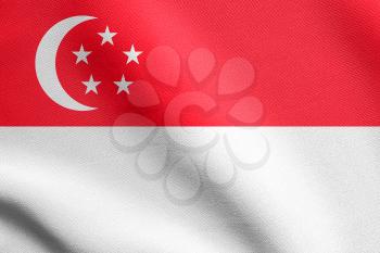 Flag of Singapore waving in the wind with detailed fabric texture. Singapore national flag.