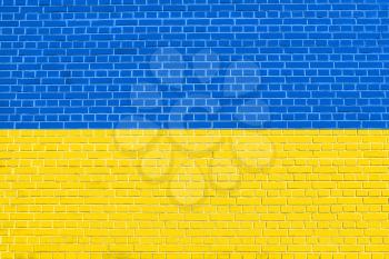 Flag of Ukraine on brick wall texture background. Ukrainian national flag.