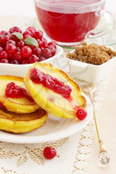 Fried pancakes with fresh cranberries and Hibiscus tea