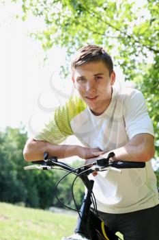 Portrait of a friendly young guy on a bike
