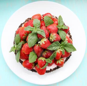 chocolate cake with juicy strawberry and mint 