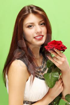 Woman with a rose on a green background