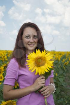 Beautiful girl in a field of sunflowers.