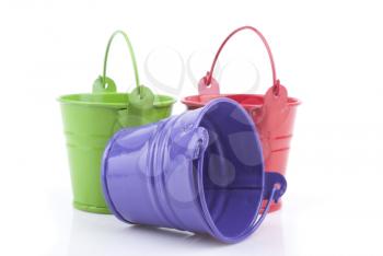 Three buckets of different colors, isolated on white background.