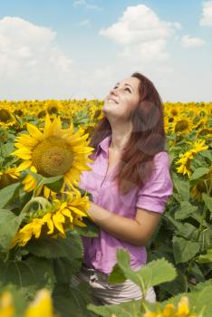 Beautiful girl in a field of sunflowers.