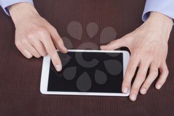 Businessman hands are touching on contemporary generic tablet pc.