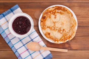 Fried pancakes and jam on the kitchen table.