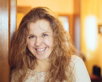 Beautiful girl woman at home looking very happy open door