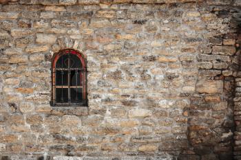 Old Wall Constructed Of Stone Bricks Background And Window With Lattice Window