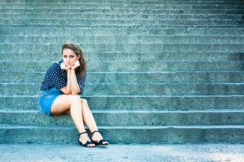 Summer Beautiful Girl Portrait. Pretty Young Caucasian Happy Woman Sitting On Staircase.