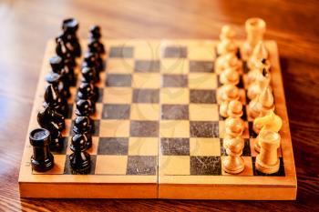 Vintage Chess Standing On Ancient Wooden Chessboard