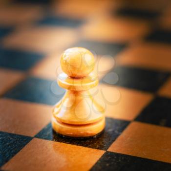 Chess White Pawn Standing On Old Vintage Chessboard