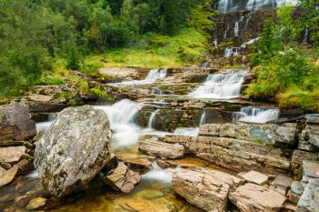 Tvindefossen Waterfall in Norway. Norwegian nature landscape at summer. Waterfall Tvindefossen is largest and highest waterfall of Norway, its height is 152 m.