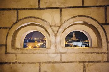 Beautiful night cityscape of Cesky Krumlov through castle window, Czech republic. UNESCO World Heritage Site