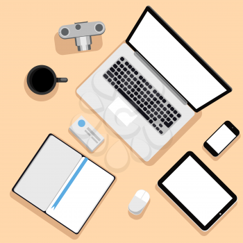 Top view of workplace with laptop, tablet, camera, smartphone, stationery and documents