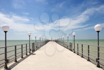 pier on the sea coast with tourists