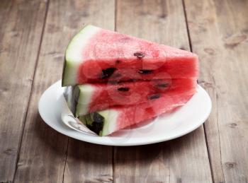 slices of watermelon on a wooden table