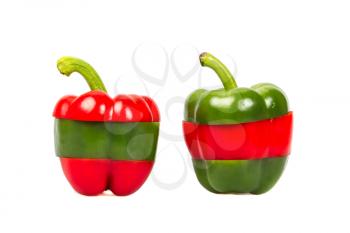 A sliced red and green pepper on a white background