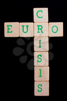 Letters on old wooden blocks (euro, crisis)