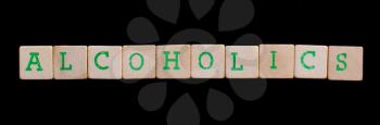Alcoholics spelled out in old wooden blocks