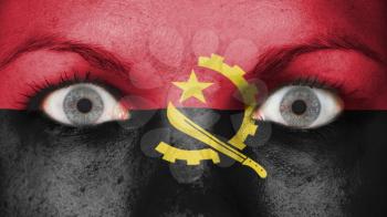 Close up of eyes. Painted face with flag of Angola