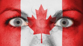 Close up of eyes. Painted face with flag of Canada