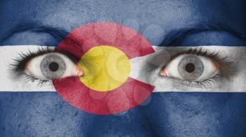 Close up of eyes. Painted face with flag of Colorado