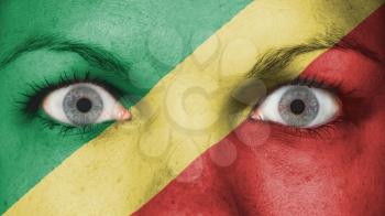 Close up of eyes. Painted face with flag of Congo